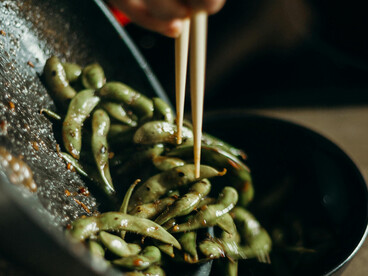 Stir-frying sweet peas and sprinkling salt on green beans — a simple example of healthy, plant-based snacks