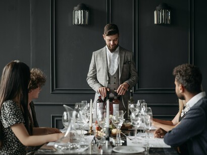 An elegant restaurant service built around exclusivity, symbolising the economics of prestige-driven demand