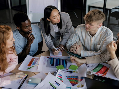 A group of skilled marketing experts actively collaborates within the confines of their office workspace