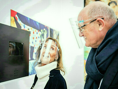 Serenella and David Ciclitira standing in front of Marina Alexeeva’s video box. STARTnet fair, 2020, Saatchi Galleryn© Tanya Naiden