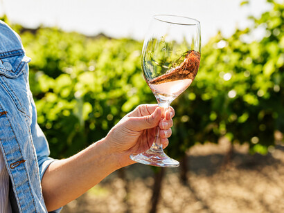 A woman tasting sweet wine, exploring the rich flavours and aromas that define dessert wines