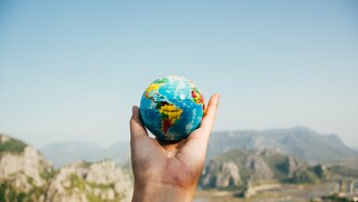 Man holding the globe with his hand