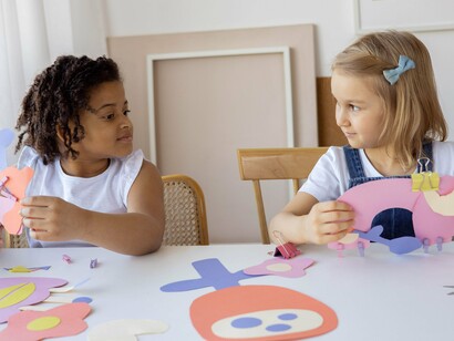 Two children sat together at a table 