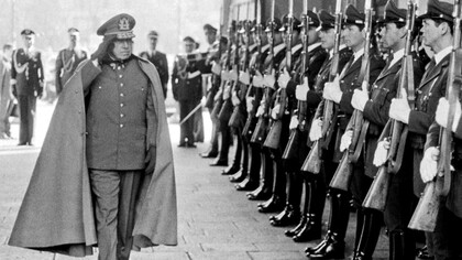 Augusto Pinochet reviews troops inside the presidential palace in Santiago, Chile in 19
