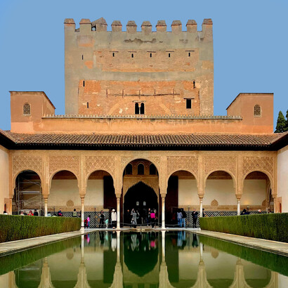 The Alhambra Palace reflected in the still waters of historic Granada, Andalusia, Spain