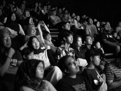 A black-and-white photo of a crowded cinema audience