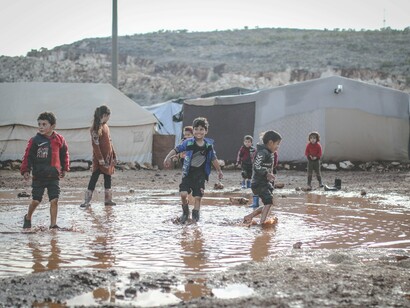 Children playing on a muddy area