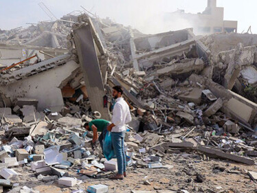 Palestinians survey the destruction caused by an Israeli airstrike in the El-Remal area of Gaza City on October 9, 2023