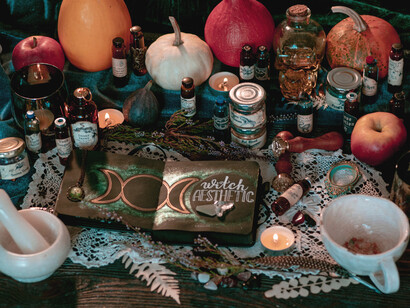 Vials, teacups, books, and candles arranged to signify mythical realms