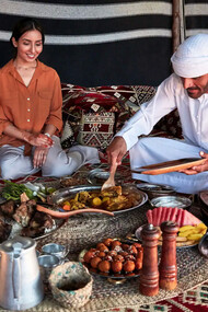 Three people from the UAE sit for traditional meal together