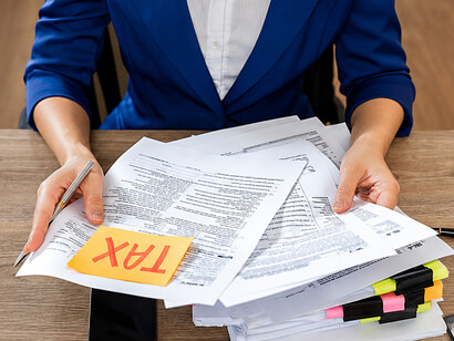 Accountant managing tax records and financial reports in an office workspace