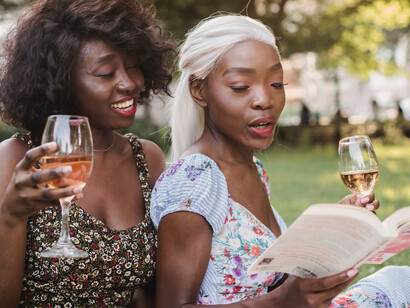 Momento de descontração em um parque com um bom livro e vinho rosé