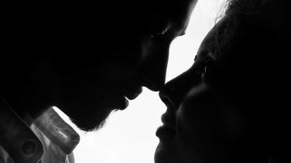 A woman and man look at each other, searching for connection beyond words