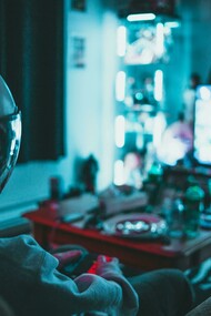 A gamer playing a video game in a dark room while wearing a gaming helmet