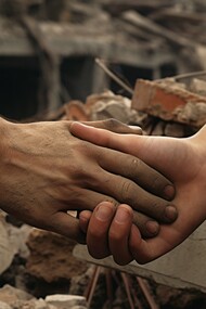 Amidst the devastation, the simple act of holding hands symbolizes the enduring human connection and the vital need for support in Gaza's immense task of "rebuilding"