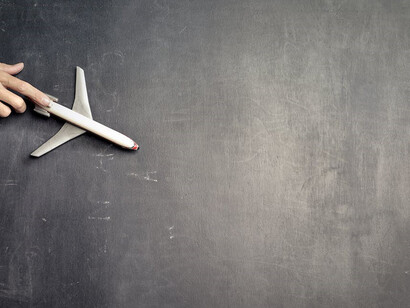 An airplane flying over a blackboard 