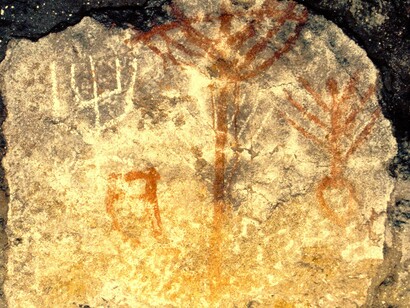Kokh tomb still partly sealed and marked with Jewish emblems including the menorah, lulab, and shofar in Jerusalem, Israel