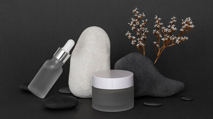 Discover the epitome of modern beauty with an artfully arranged display showcasing an array of luxurious skincare and makeup products in sleek, minimalist recipients