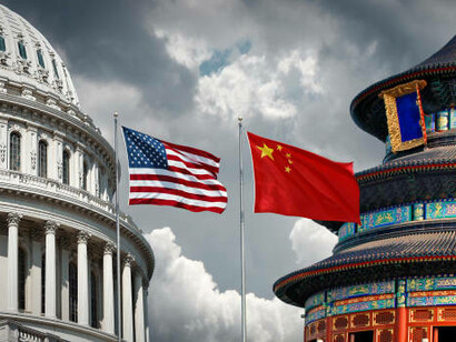 The United States and China flags wave above the White House, representing the ongoing diplomatic tensions, sanctions, and embargoes that shape the relationship between the two powers