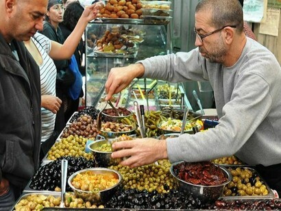 A seller, working in Mahane Yehuda 