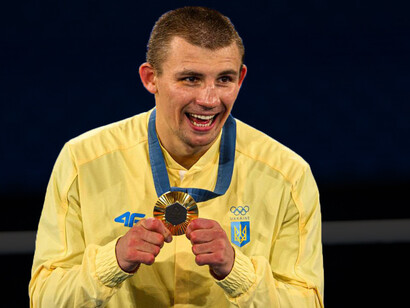 Gold medalist and Olympic champion Oleksandr Khyzhniak at the victory ceremony of the Men's 80 kg at the Roland-Garros Stadium in Paris, 2024, France