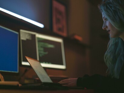 A woman working as a programmer, typing on a keyboard