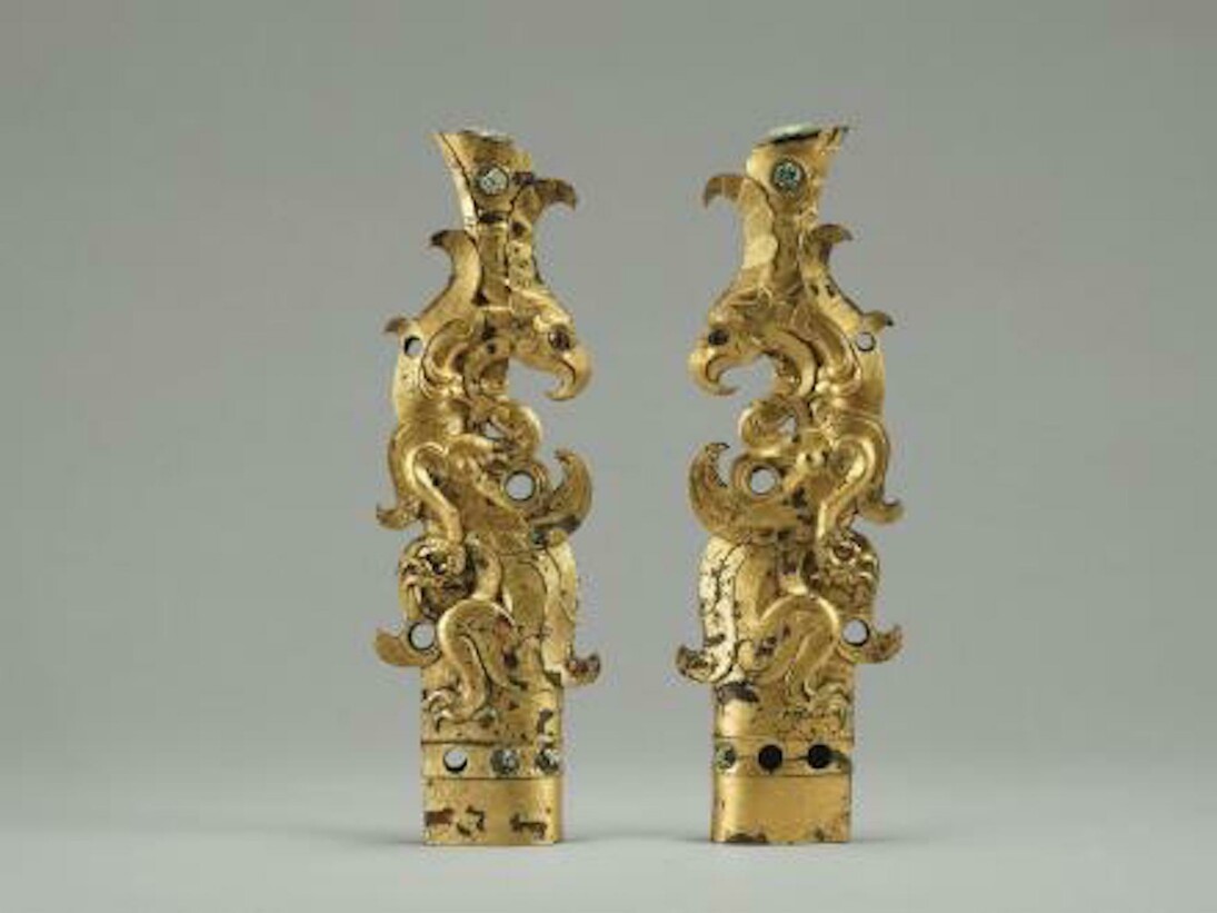 Pair of Finials in the Shape of Mythical Beasts
Qin dynasty (221–206 B.C.). Gilt bronze inlaid with glass, each 10⅝ x 3½ x 1⅛ in. (27 x 9 x 3 cm). Unearthed in 1972, the Second Brick Factory site, northern suburb of Xi’an, Shaanxi Province. Photo: Courtesy Xi’an Museum