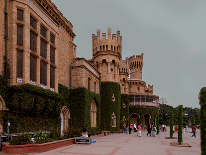 Bangalore Palace, a historic landmark in the city, features grand stone architecture with ivy-covered walls and multiple towers, India