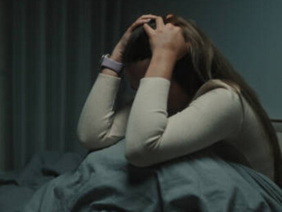 A desperate woman, overwhelmed by anxiety and sorrow, lost in the silence of the night