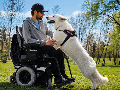 A man with a disability spending time in a park alongside his loyal service dog