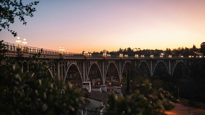 The Colorado Street Bridge glows at dusk, a timeless Pasadena landmark linking history, architecture, and California charm