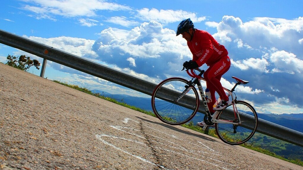 Un ciclista asciende por la escarpada pendiente de Peña Cabarga