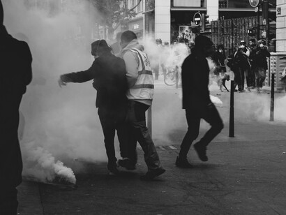 A thick haze of tear gas hangs over the street as protesters clash with authorities