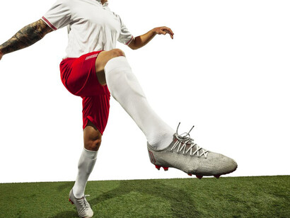 A soccer player showcases their skills in motion against a white background