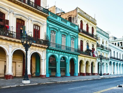 The vibrant colonial architecture of Havana, with its stately, brightly colored buildings and arched walkways, reflects the city's unique blend of historical grandeur and ongoing restoration efforts