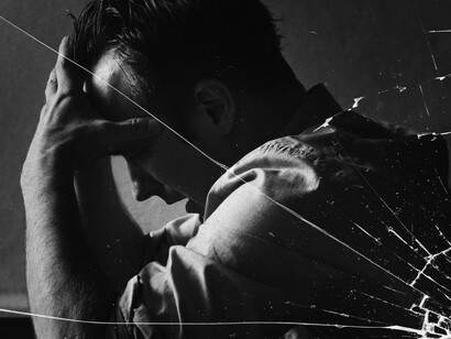 The crack in the glass is not from the outside world, but from years of surviving without feeling