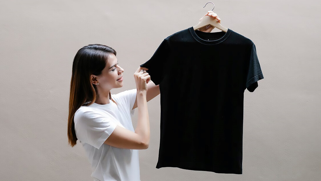 A woman displaying a sleek black t-shirt