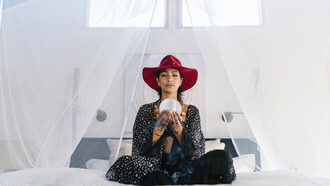 Woman meditating holding a crystal ball