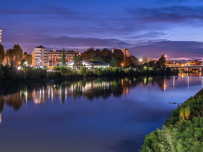 The Tanaro River flows quietly through Alessandria, Piedmont, under the night sky