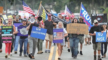 Demonstrators march against the wearing of face masks in downtown Sanford, Florida, where locals, like their pioneer forebears, have been resisting government orders © Joe Burbank/Orlando Sentinel/AP 