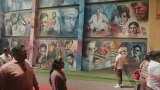A picture from Film City, Mumbai showing a mural featuring various Bollywood actors and characters, India