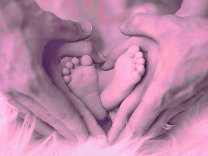 A husband and his wife make a heart around their new baby's feet