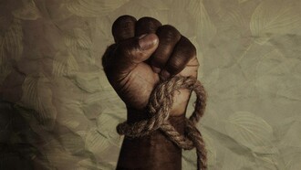 A bound hand clenched in resistance, the rope tightening around the wrist as a stark reminder of how slavery reduced human beings to property