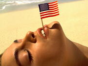 Albert Watson, Cindy Crawford with flag, U.S. Virgin Islands, 1993. Courtesy of Fahey/Klein Gallery