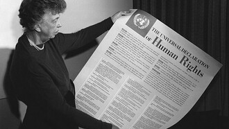 Eleanor Roosevelt holding poster of the Universal Declaration of Human Rights, Lake Success, New York. November 1949