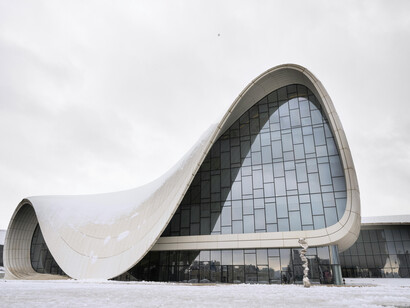 Designed by Zaha Hadid Architects, the Heydar Aliyev Center stands out against a snowy backdrop in Baku, Azerbaijan, with its fluid and futuristic for
