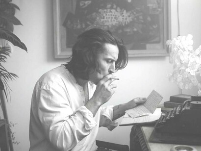 A writer reading a piece of poetry he had just composed