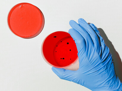 A hand in a plastic glove putting samples together