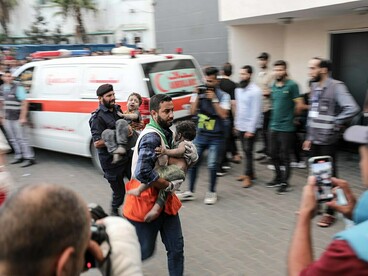 An injured Palestinian child is transported by medics to Al-Shifa Hospital in Gaza City after an Israeli airstrike on October 11, 2023, illustrating the human cost of conflict