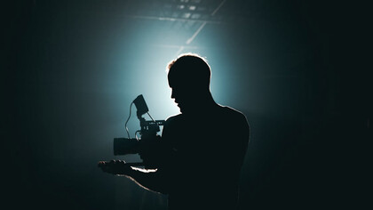 On set with a camera in hand, capturing the magic of film production where AI is the unsung hero behind the scenes, enhancing visual effects and streamlining editing